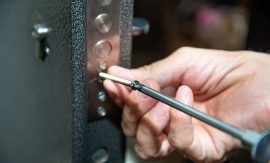 man-repairs-door-lock-closeup-260nw-1518815528.jpg