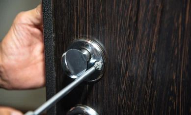 man-repairs-door-lock-closeup-260nw-1536631334.jpg